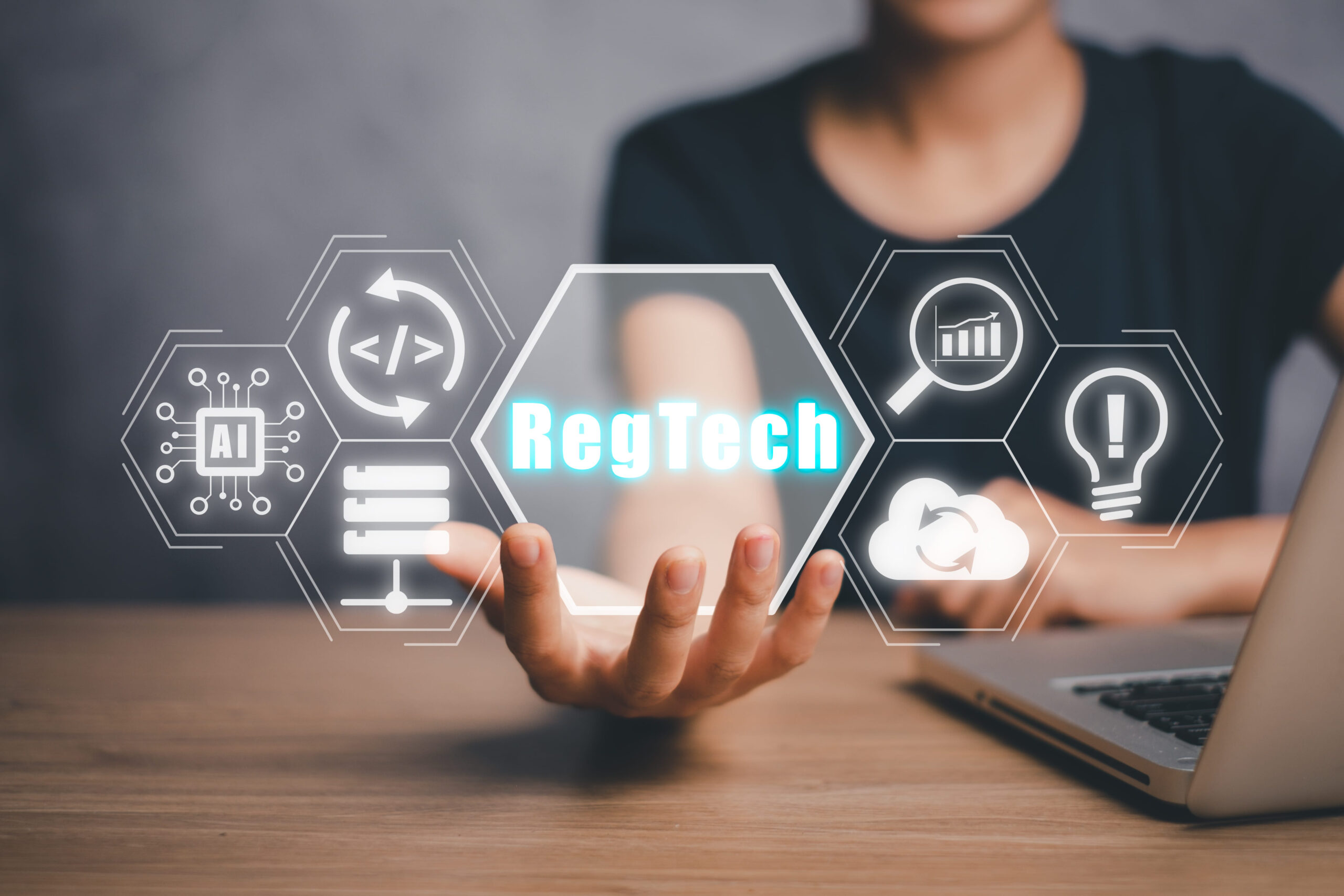 RegTech, Regulation Compliance financial control modern internet technology concept, Person hand holding RegTech icon on virtual screen.