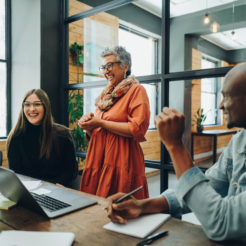 Diverse Businesspeople Smiling Cheerfully During An Office Meeting